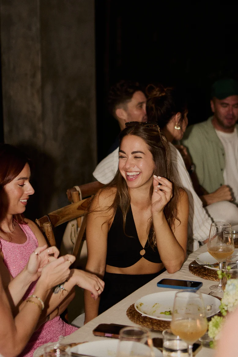 Guests laughing at a private celebration dinner at Villa Zambala Canggu